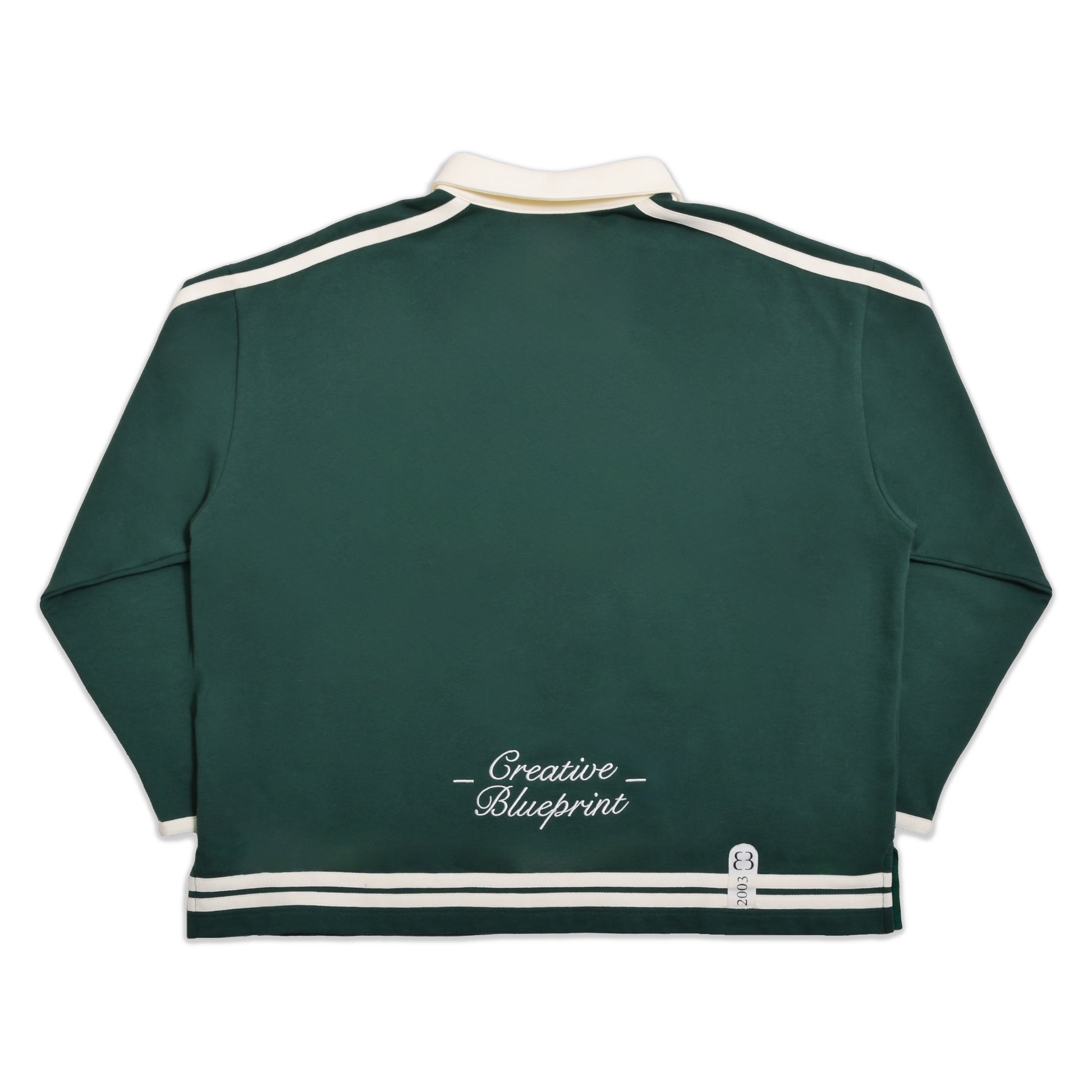 A full back view of our forest green Inner Child Rugby shirt. The same cream striping is present on the back view with a single embroidery hit centered at the bottom of the garment, just above the stripes, spelling "Creative Blueprint" in a script font. The cream collar is also visible at the top of the photo.